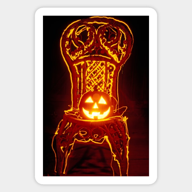 Carved smiling pumpkin on chair Sticker by photogarry